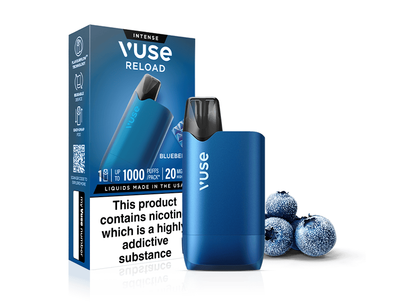 A blue Vuse Reload vape device stands in front of its matching box, which displays product details. Three frosted blueberries lie beside them. A nicotine warning label is visible on the box.