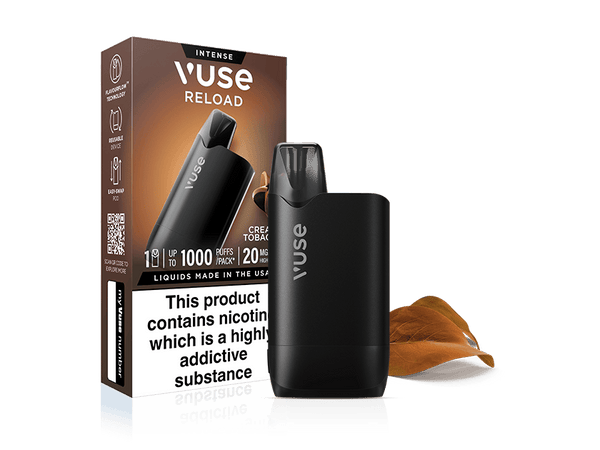 A Vuse Creamy Tobacco Reload vape in black stands by its packaging, labeled "Creamy Tobacco Vuse Reload Box," with Extra Intense Pods highlighted. A few tobacco leaves are placed next to the device.