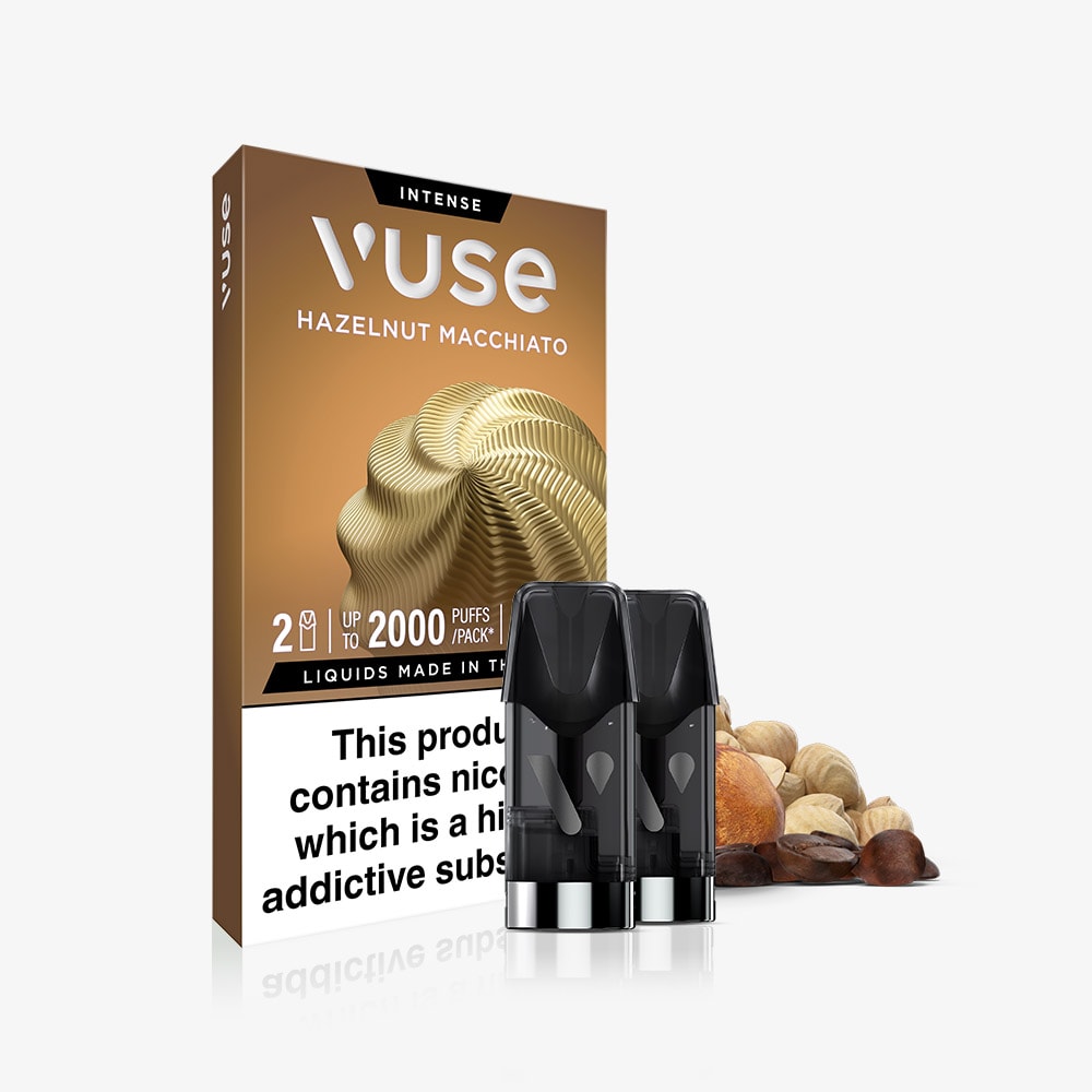 The Hazelnut Macchiato Vuse Extra Intense Flavour Pods feature two black pre-filled pods, swirled brown designs, a warning label, and coffee bean accents—Vuse PRO compatible for a smooth, coffee-inspired vape experience.