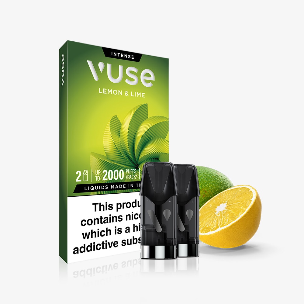 A box of Vuse Lemon & Lime Extra Intense Flavour Pods is displayed with two pre-filled e-liquid pods, a whole lime, and half a lemon. The green box includes leaf graphics and a nicotine warning label at the bottom.