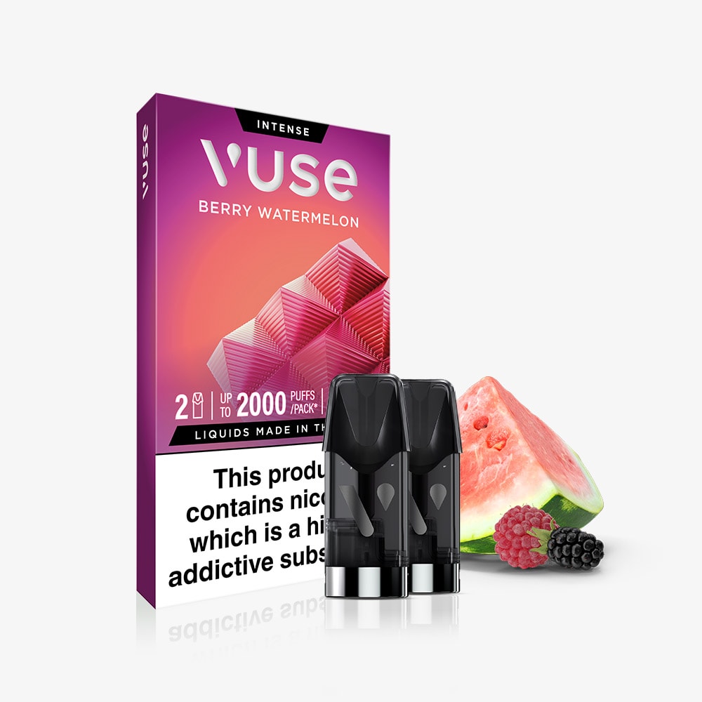 A pack of Berry Watermelon Vuse Extra Intense Flavour Pods, containing two Vuse PRO-compatible pre-filled pods, is placed in front of a watermelon slice and berries. The Vuse packaging shows a nicotine warning label at the bottom.