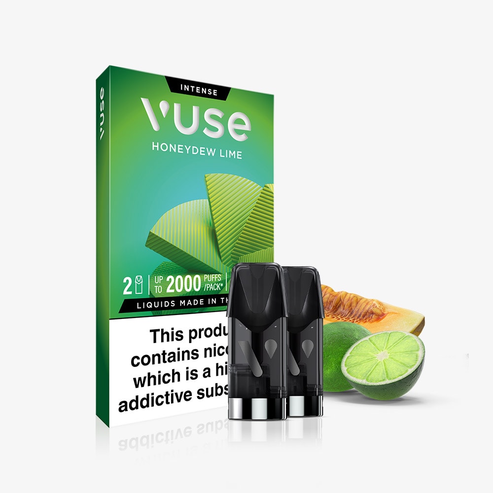 A box of Honeydew Lime Vuse Extra Intense Flavour Pods with two black Vuse pods in front. Next to the box are honeydew melon and lime slices. The packaging features a nic salts nicotine warning label.