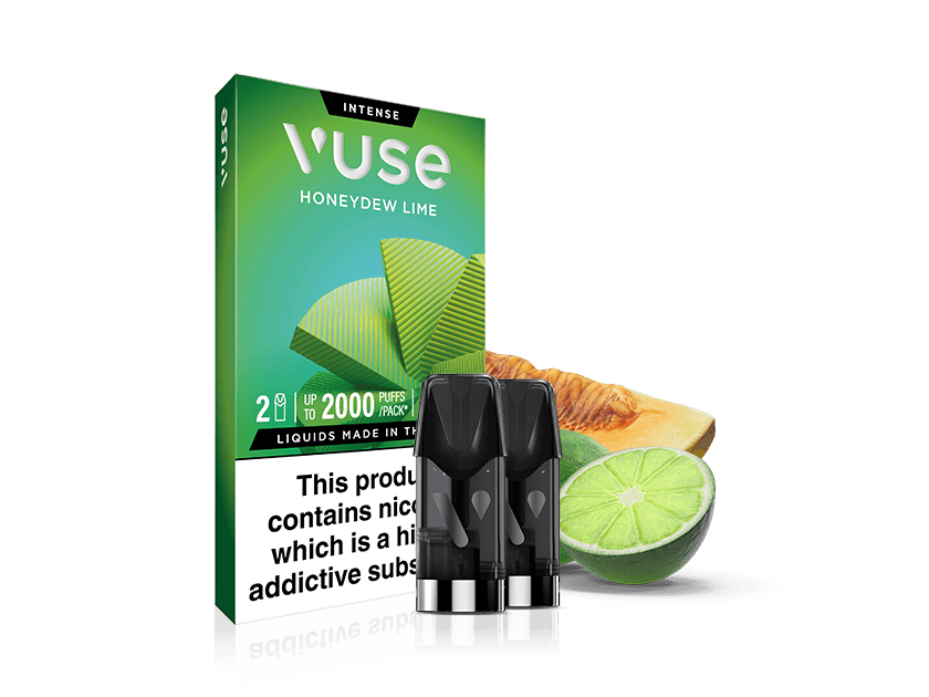 Green Vuse Honeydew Lime vape cartridge box with three black cartridges in front, next to a sliced honeydew melon and a lime. The box includes a nicotine addiction warning label.