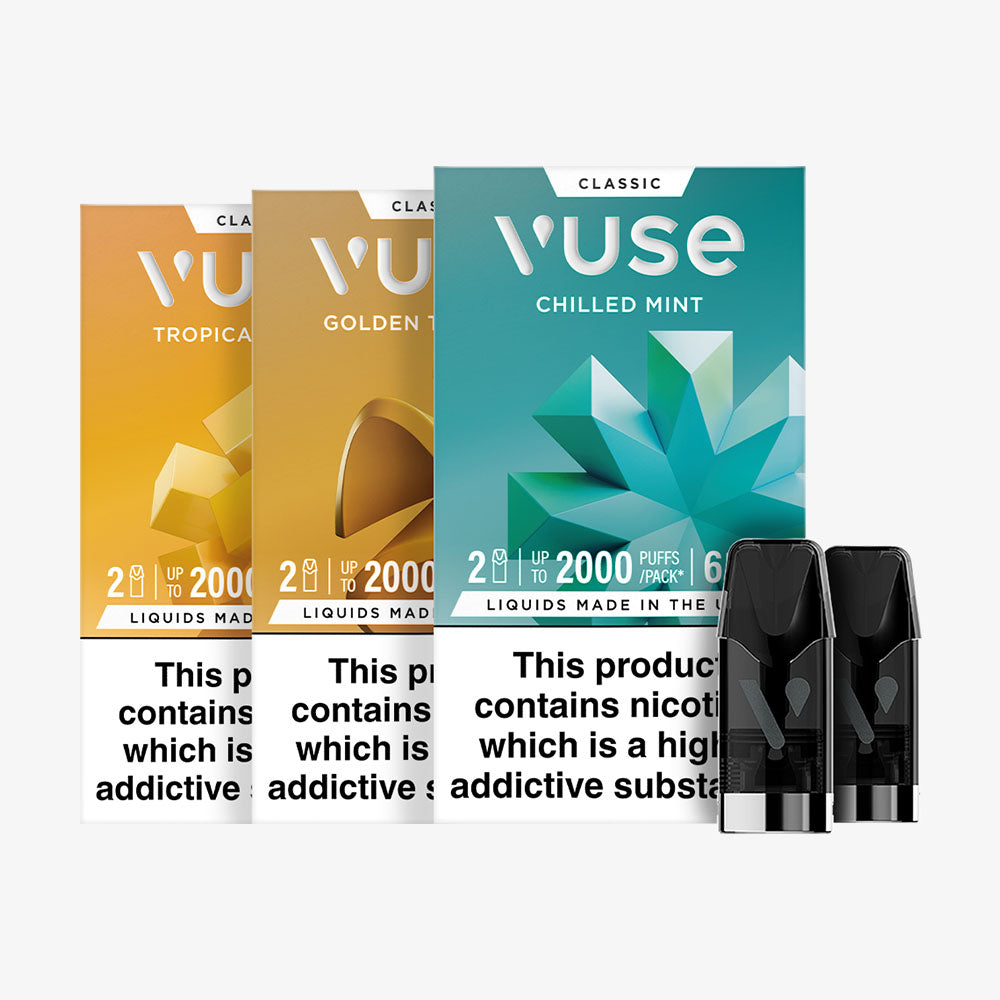 Three Vuse vape pod packs in Tropical Mango, Golden Tobacco, and Chilled Mint flavors are shown upright, with two black pods in front. Health warnings about nicotine as an addictive substance appear on the packaging.