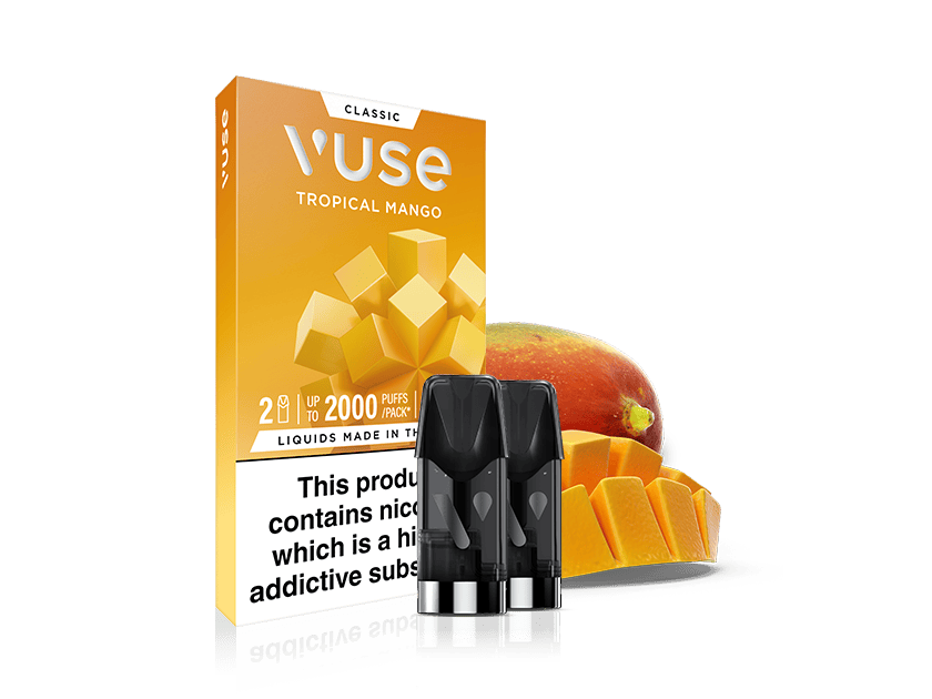 A Vuse Tropical Mango e-liquid pack is shown with three vape pods in front. The packaging is orange with mango graphics, and a sliced mango and whole mango appear beside it. A nicotine warning label is visible.